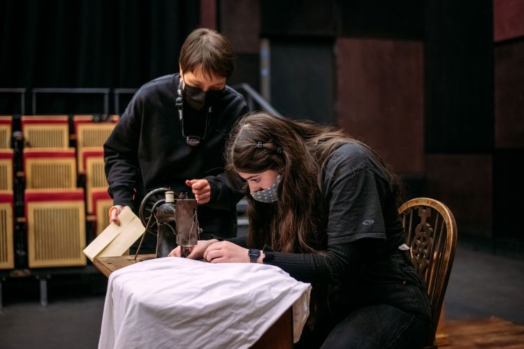 Stage Management students checking a prop on stage